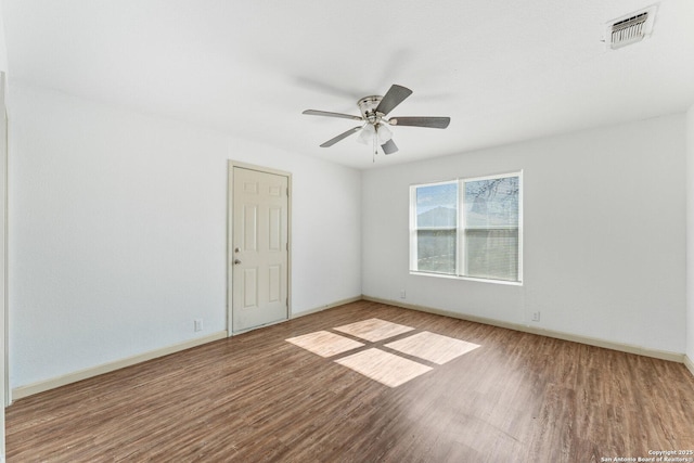 spare room featuring wood-type flooring and ceiling fan