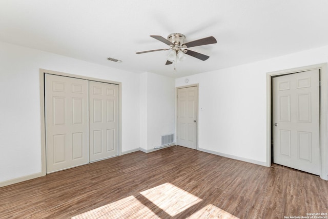 unfurnished bedroom with a closet, hardwood / wood-style flooring, and ceiling fan