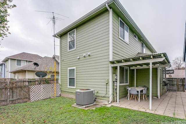 back of house with a yard, central AC unit, and a patio area