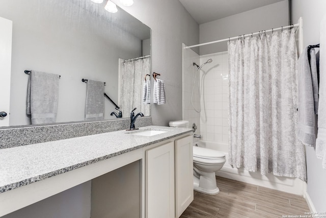 full bathroom with vanity, shower / bath combo, and toilet