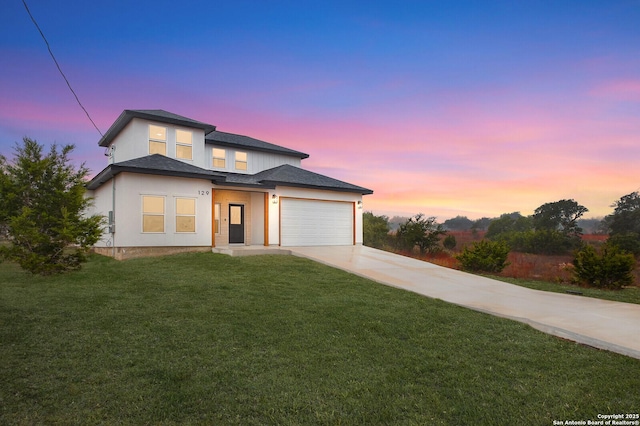 view of front of property with a lawn and a garage