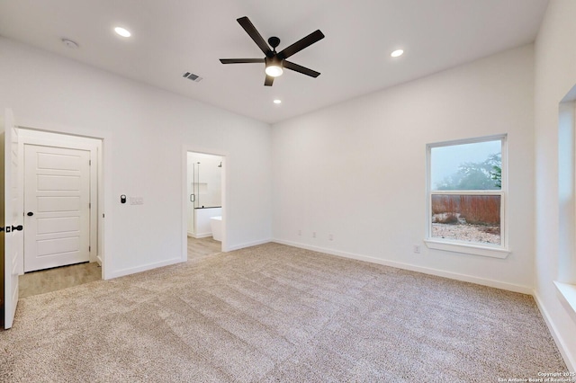 unfurnished bedroom featuring ensuite bath, ceiling fan, and light carpet