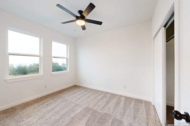 unfurnished bedroom with carpet, ceiling fan, and a closet