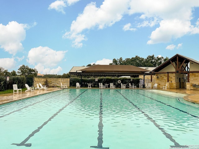 view of swimming pool with a patio