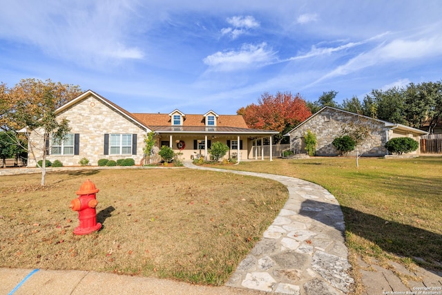 view of front of house with a porch and a front yard