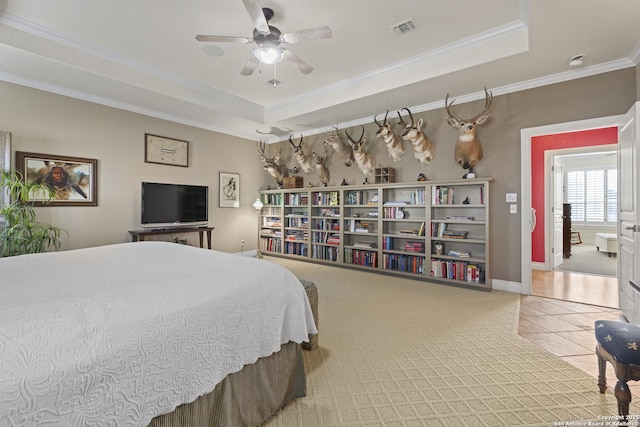 bedroom featuring ceiling fan, a raised ceiling, crown molding, and light carpet