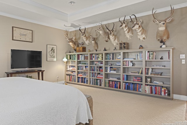 bedroom with ornamental molding, carpet floors, and a tray ceiling