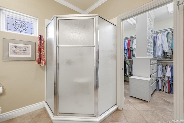 bathroom featuring tile patterned floors, crown molding, and a shower with door