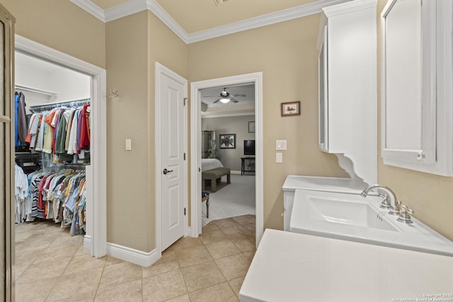 laundry room with ceiling fan, ornamental molding, sink, and light tile patterned floors