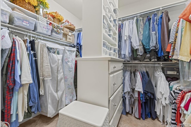 spacious closet with light tile patterned floors