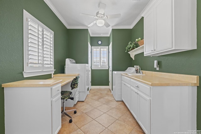 clothes washing area with cabinets, crown molding, washer and dryer, ceiling fan, and light tile patterned flooring