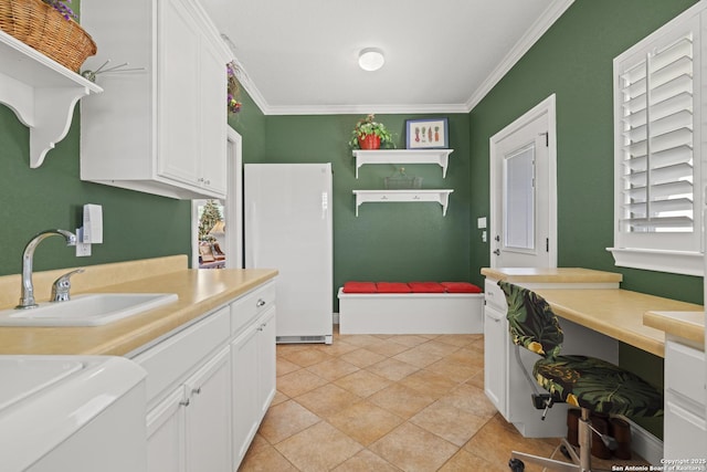 bathroom featuring tile patterned flooring, ornamental molding, and sink