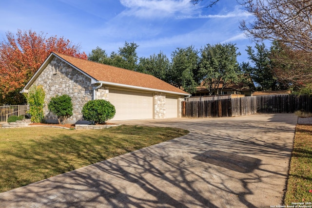 view of side of property featuring a lawn and a garage