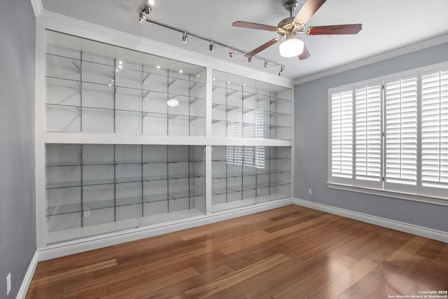 2166 Lightstone, Fredericksburg, TX 78624 - empty room with baseboards, track lighting, ceiling fan, wood finished floors, and ornamental molding