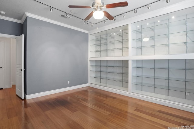 2166 Lightstone, Fredericksburg, TX 78624 - spare room featuring track lighting, crown molding, ceiling fan, wood finished floors, and baseboards