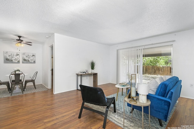 interior space featuring ceiling fan, dark hardwood / wood-style flooring, and a textured ceiling