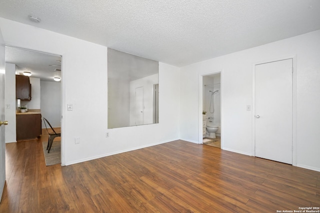 interior space featuring dark hardwood / wood-style floors and a textured ceiling