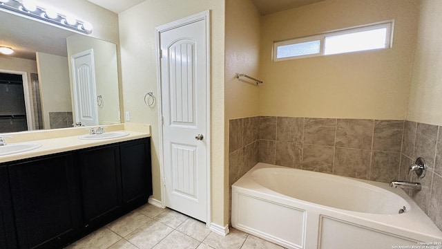 bathroom featuring a bathing tub, tile patterned flooring, and vanity