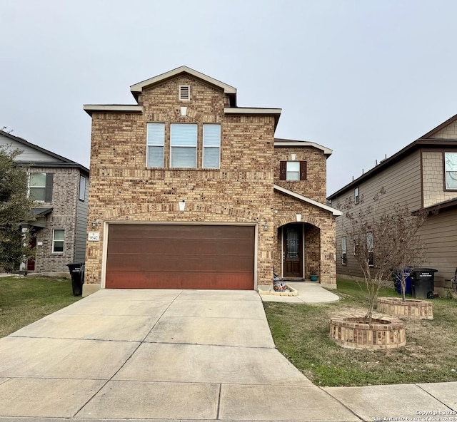 front of property featuring a front lawn and a garage