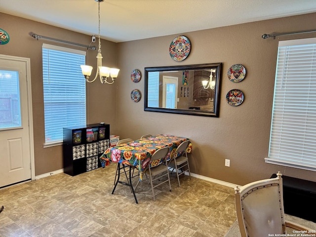 dining space with a chandelier