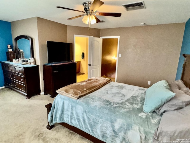 bedroom with ceiling fan and light carpet