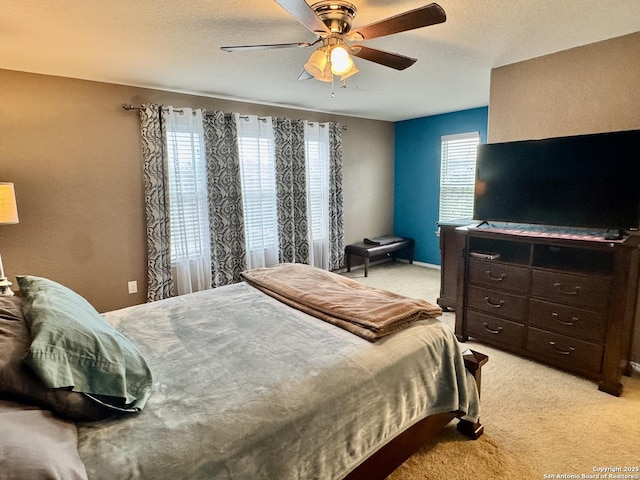 carpeted bedroom featuring a textured ceiling and ceiling fan