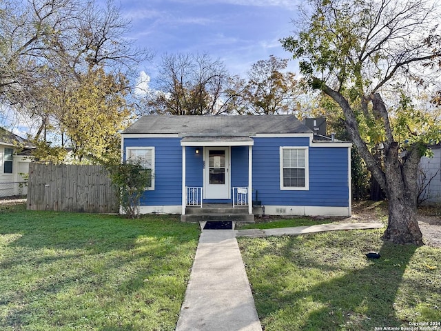 bungalow-style home with a front yard