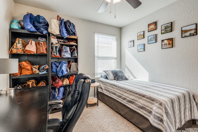 bedroom with carpet, a textured ceiling, and ceiling fan