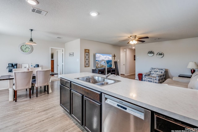 kitchen with sink, hanging light fixtures, light hardwood / wood-style flooring, stainless steel dishwasher, and ceiling fan