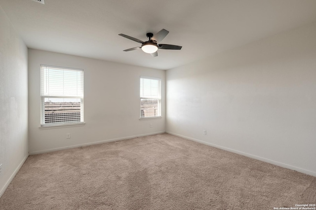 spare room with light carpet and ceiling fan