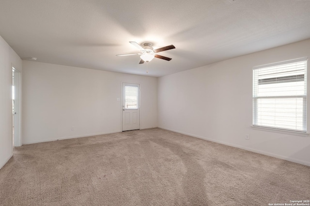 carpeted empty room featuring ceiling fan