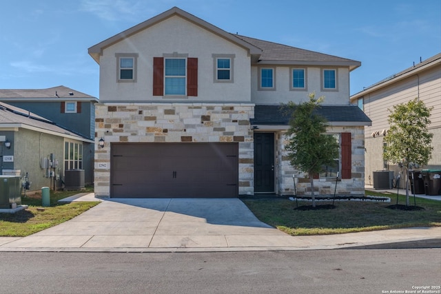 view of front of house featuring a garage and central AC unit