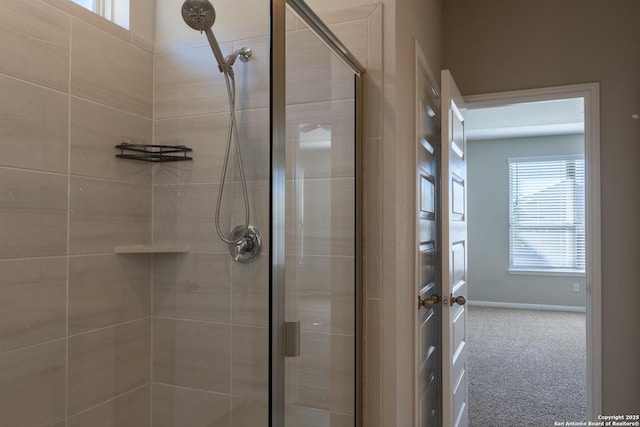 bathroom with a shower with door