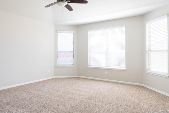 carpeted empty room featuring ceiling fan