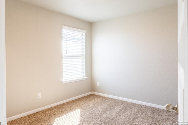 carpeted spare room featuring a wealth of natural light