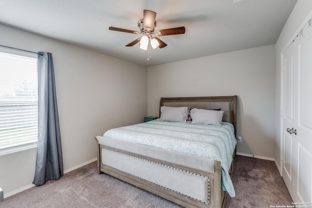 bedroom with ceiling fan, light colored carpet, and multiple windows