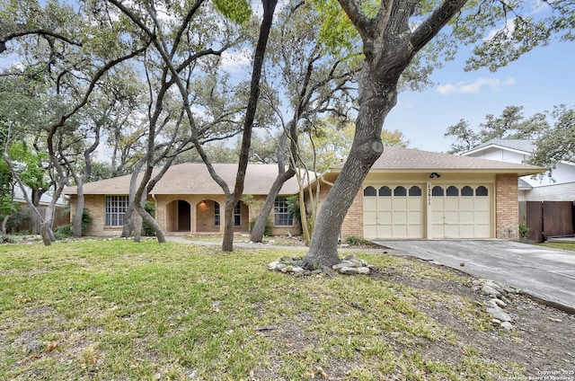 single story home with a garage and a front lawn