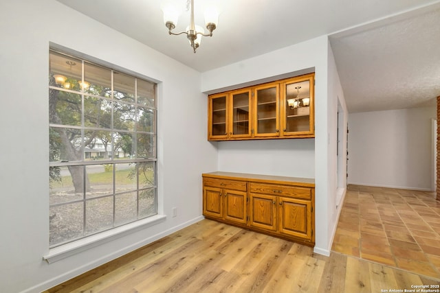 dining area featuring a chandelier and light wood-type flooring