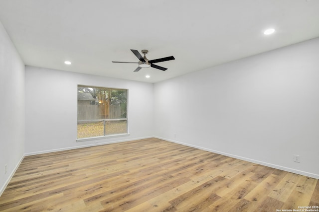 empty room featuring ceiling fan and light wood-type flooring