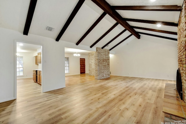 unfurnished living room with beamed ceiling, high vaulted ceiling, light hardwood / wood-style flooring, and an inviting chandelier