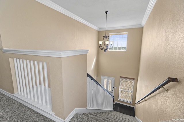 stairway with an inviting chandelier and crown molding