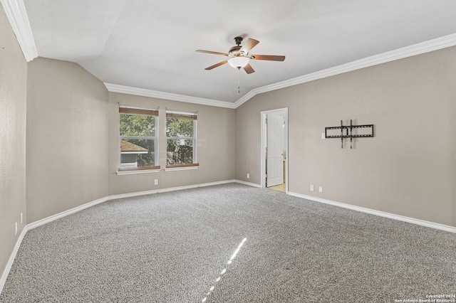 spare room with ceiling fan, crown molding, carpet floors, and vaulted ceiling