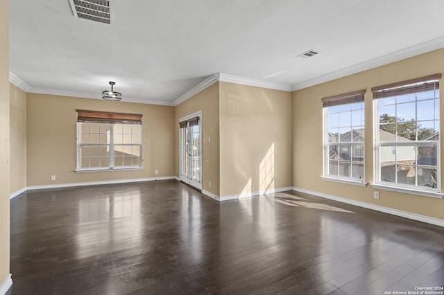 empty room with ornamental molding and dark wood-type flooring