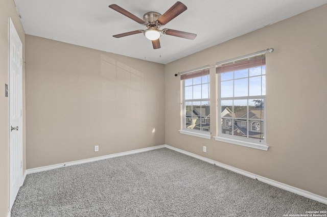 carpeted empty room featuring ceiling fan