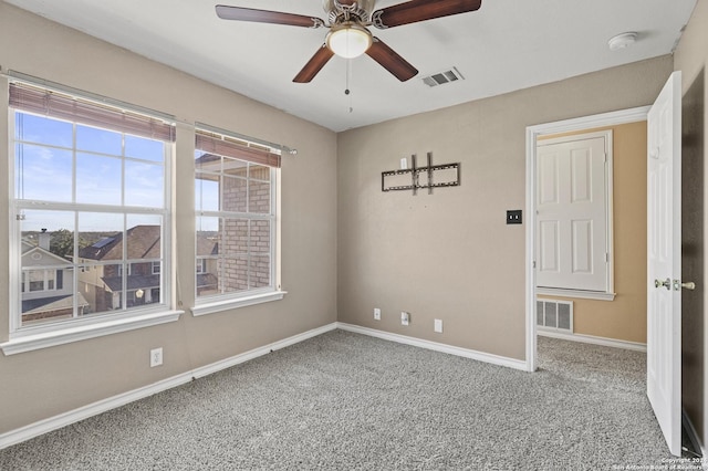 spare room with ceiling fan and carpet floors