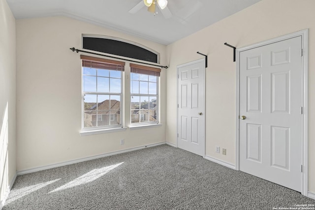 unfurnished bedroom with ceiling fan, carpet, and lofted ceiling