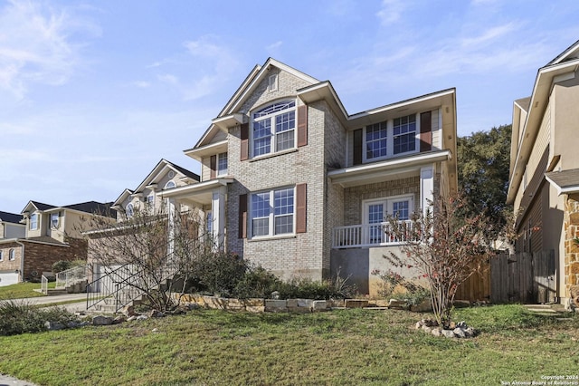 view of front of house featuring a porch and a front yard