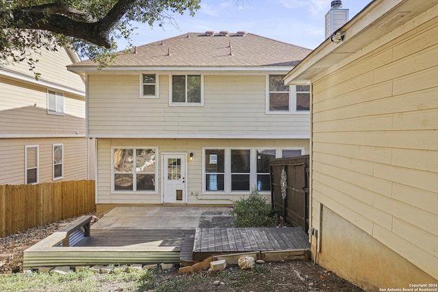 rear view of house featuring a wooden deck