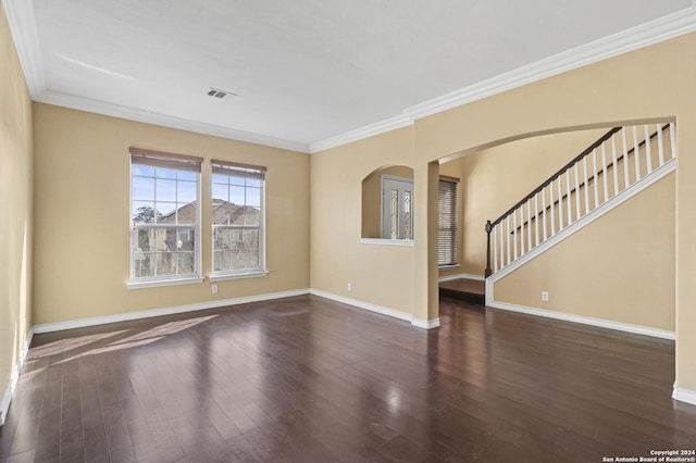 spare room featuring dark wood-type flooring and ornamental molding