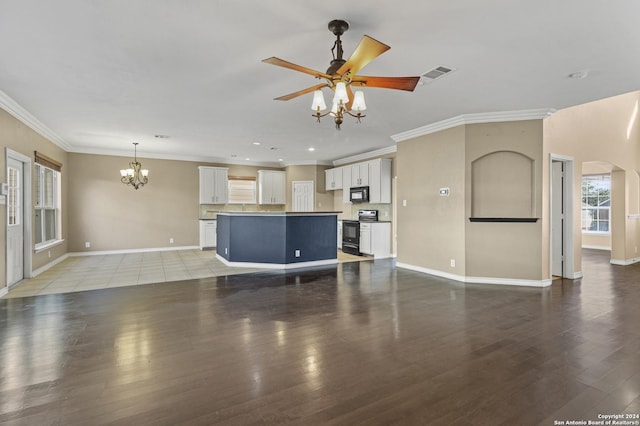 unfurnished living room featuring crown molding, ceiling fan with notable chandelier, and light wood-type flooring